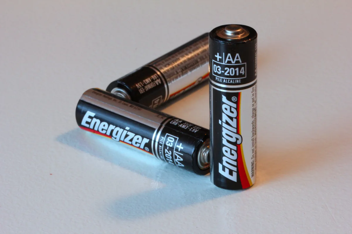 Three AA batteries arranged so that, from this one angle, they appear to form an impossible triangle.